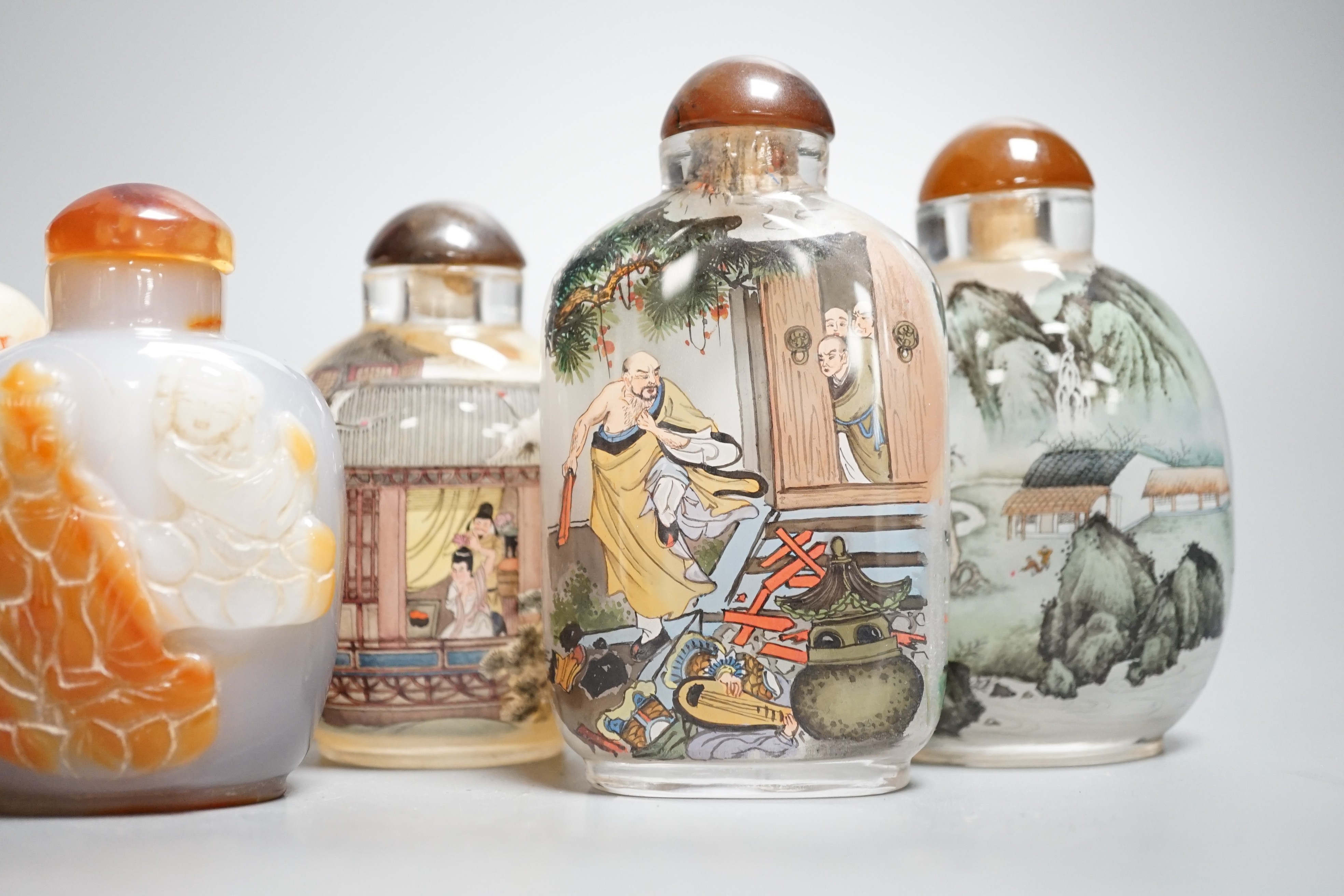 Six Chinese inside painted glass snuff bottles, an agate cameo snuff bottle and an incised crackle glaze snuff bottle, tallest 9cm